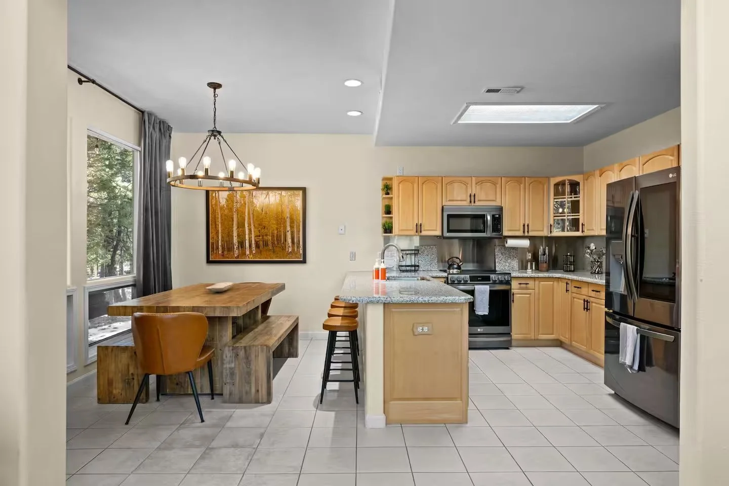Wooden dining table and bar stools beside the kitchen