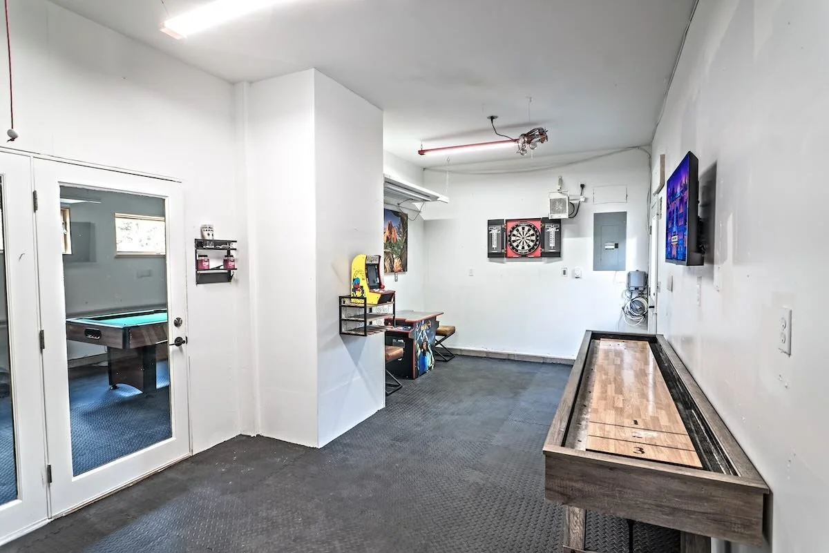 Recreation room with dartboard, mounted TV and shuffleboard table