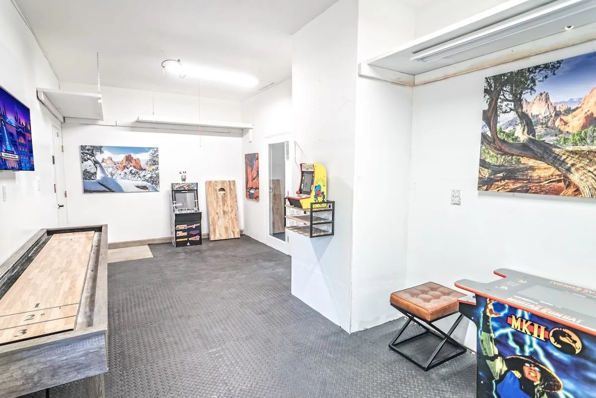 Game room with air hockey table, arcade cabinet and wall art