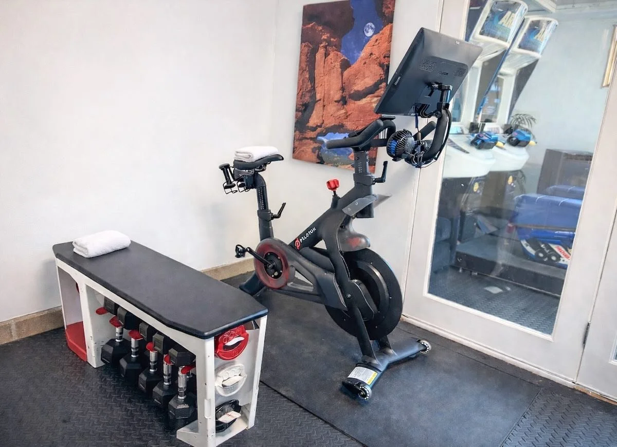 Fitness corner with stationary bike and a bench with weights
