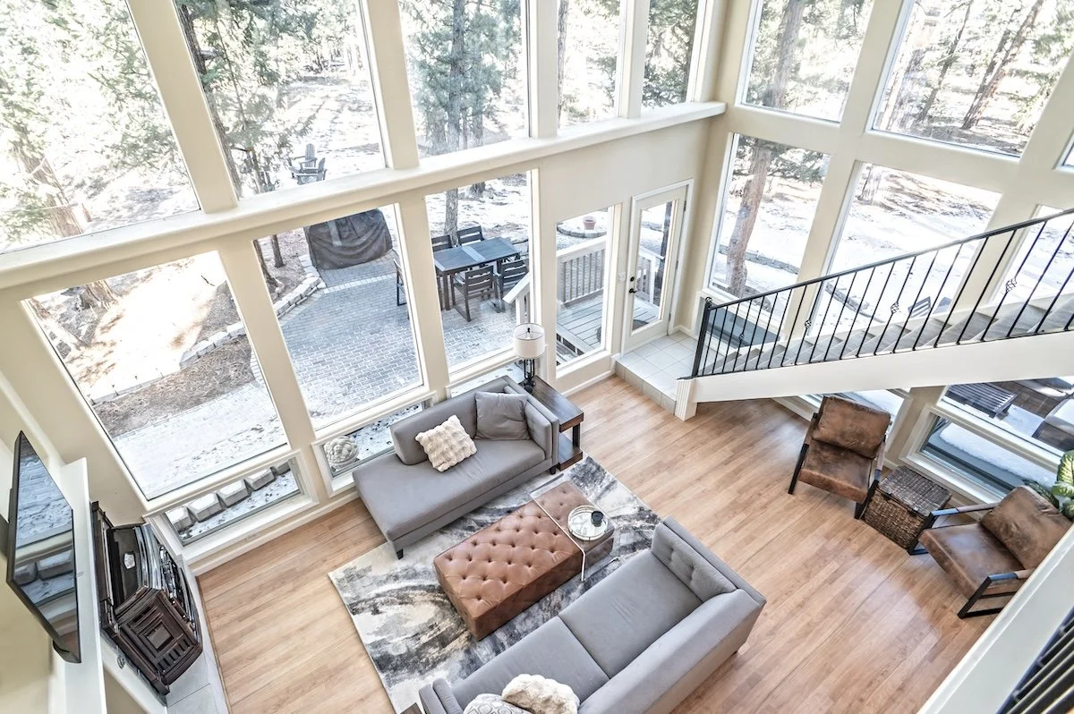 Living room with floor-to-ceiling windows looking onto a snowy patio