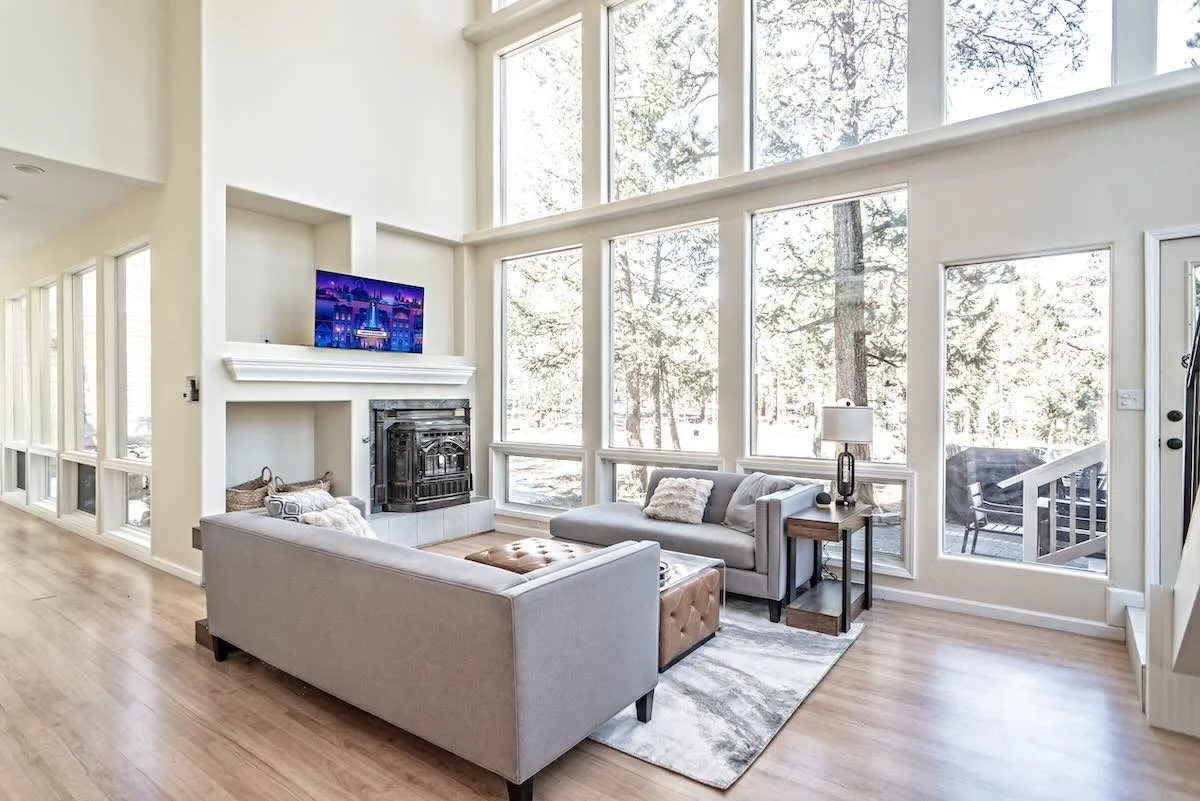 Living room with white fireplace, mounted TV and patterned rug