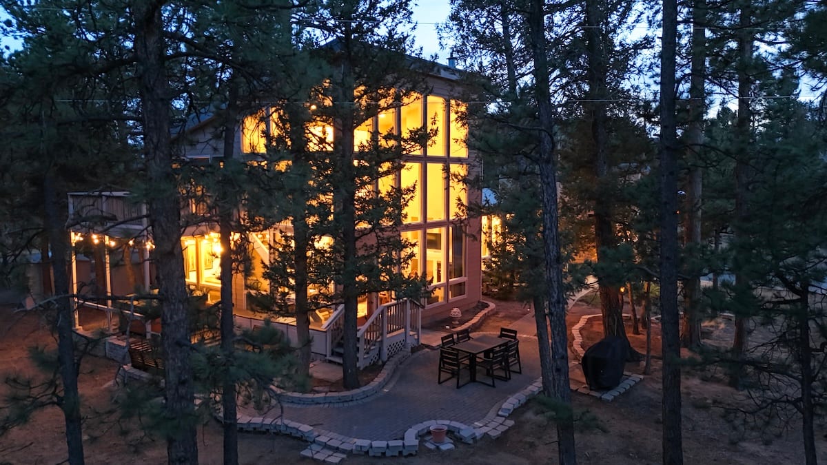 The Stillwood Retreat and surrounding pines at blue hour